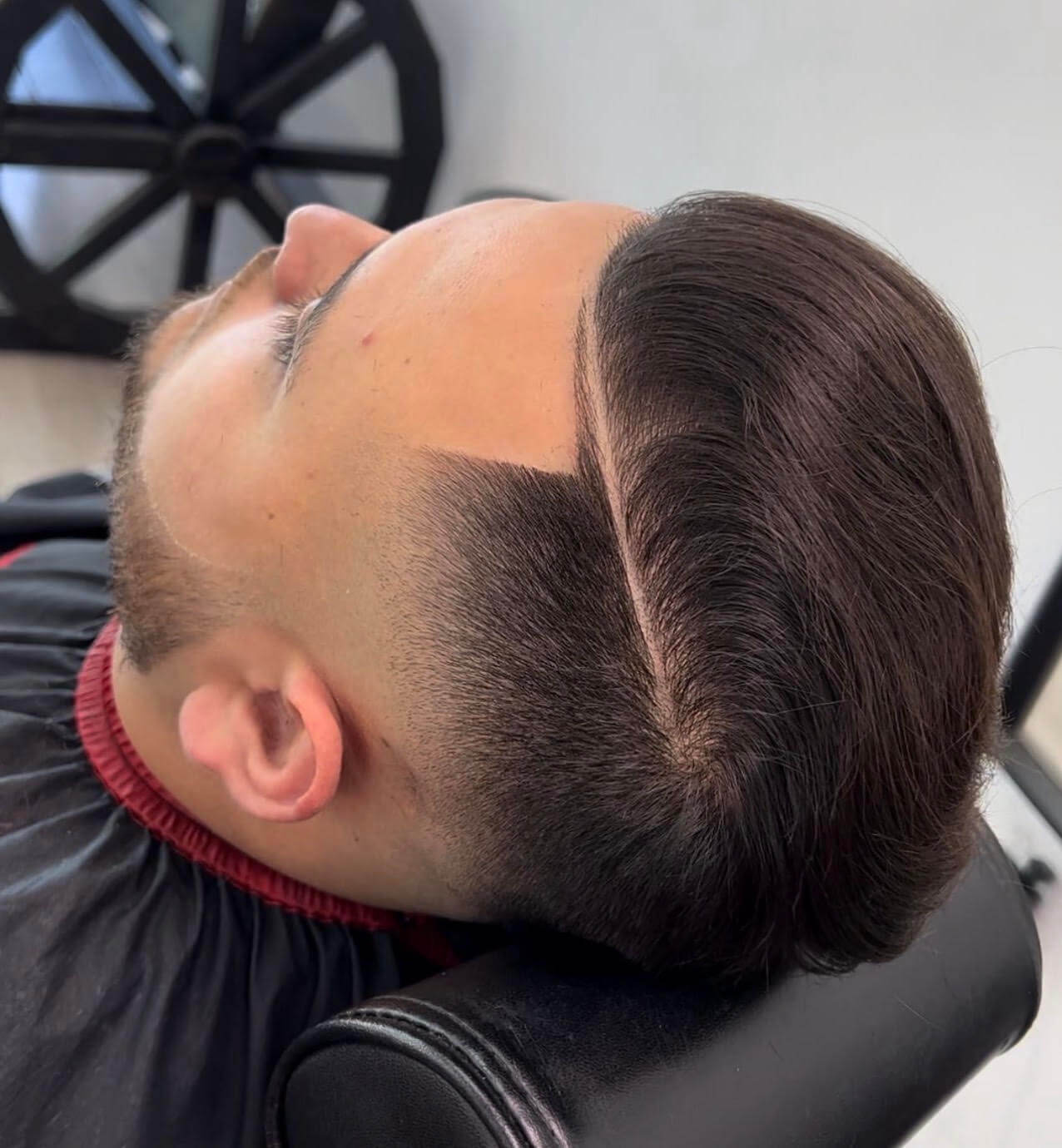 Client with a fresh side-part fade haircut